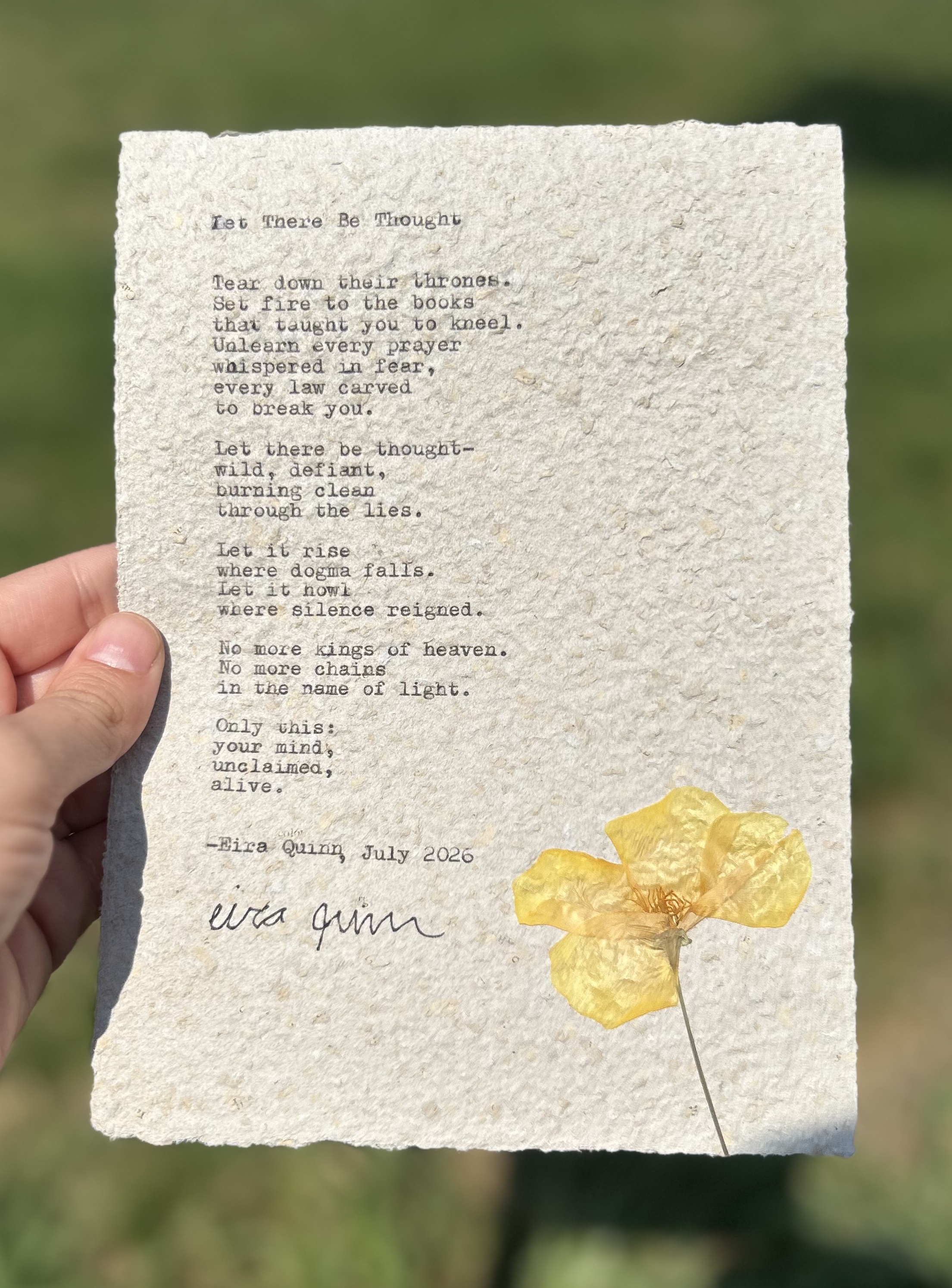 Let There Be Thought typed on handmade paper with pressed flower